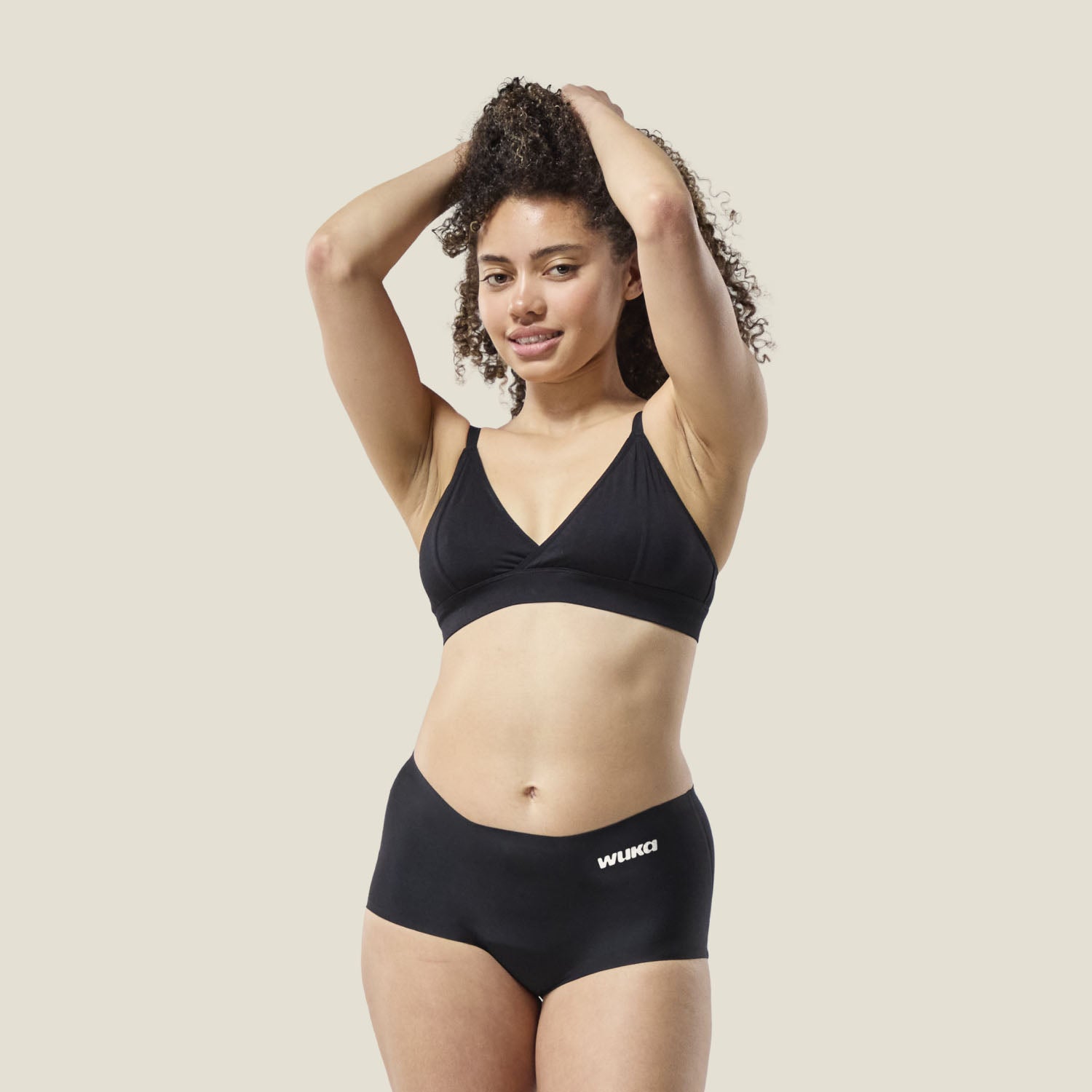 Teen model wearing WUKA Teen Stretch™ Boxer in black for heavy flow, showcasing full-length fit and comfort.