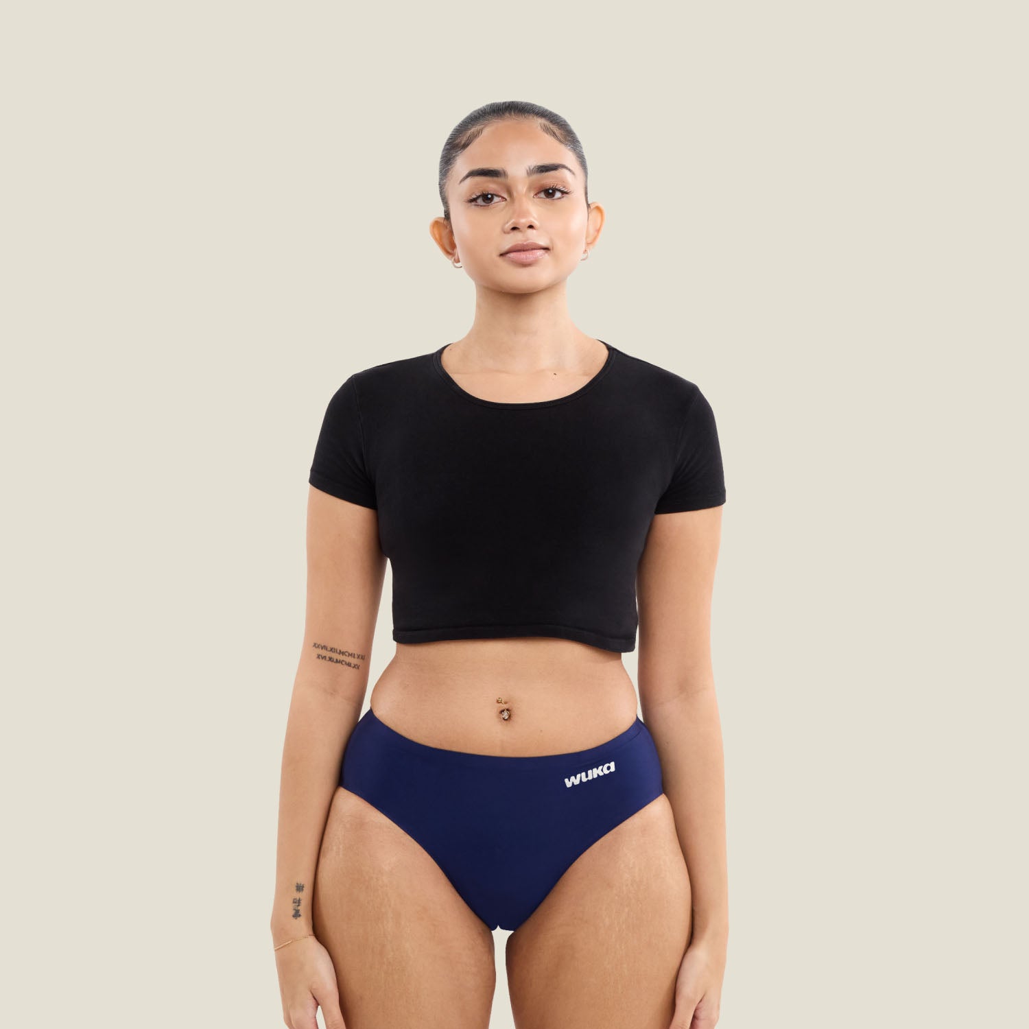 Teen girl wearing WUKA Teen Stretch™ Seamless period pants in navy, showcasing full-body fit for super heavy flow protection.