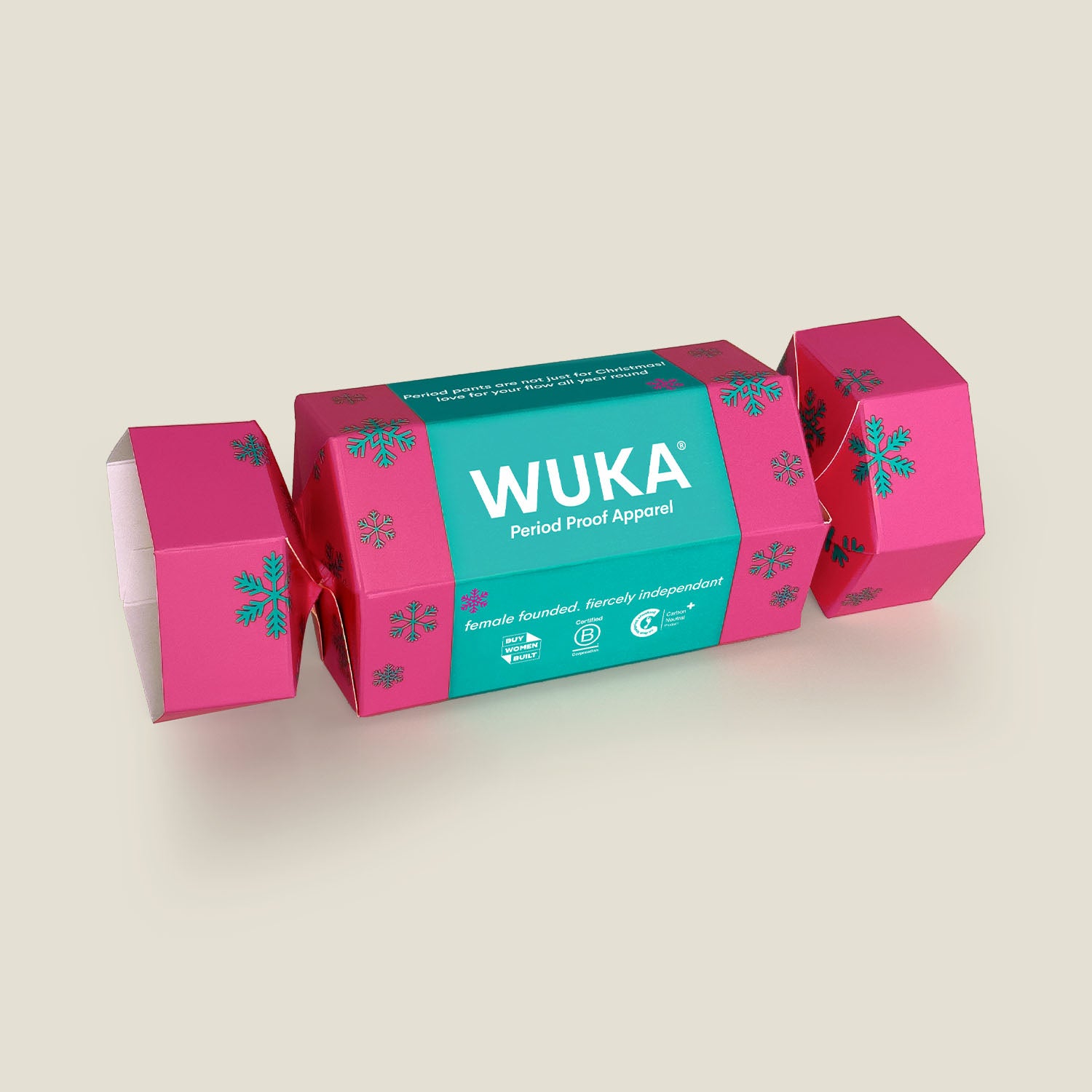 WUKA Cracker Gift Box in vibrant pink with teal branding and snowflake print – a sustainable, zero-waste festive gift containing period underwear.