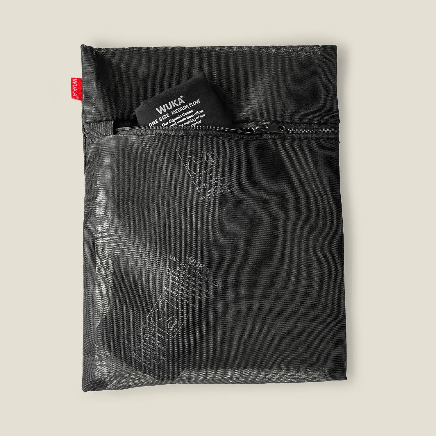 WUKA mesh laundry bag holding folded reusable period pads, showcasing transparent breathable mesh material.