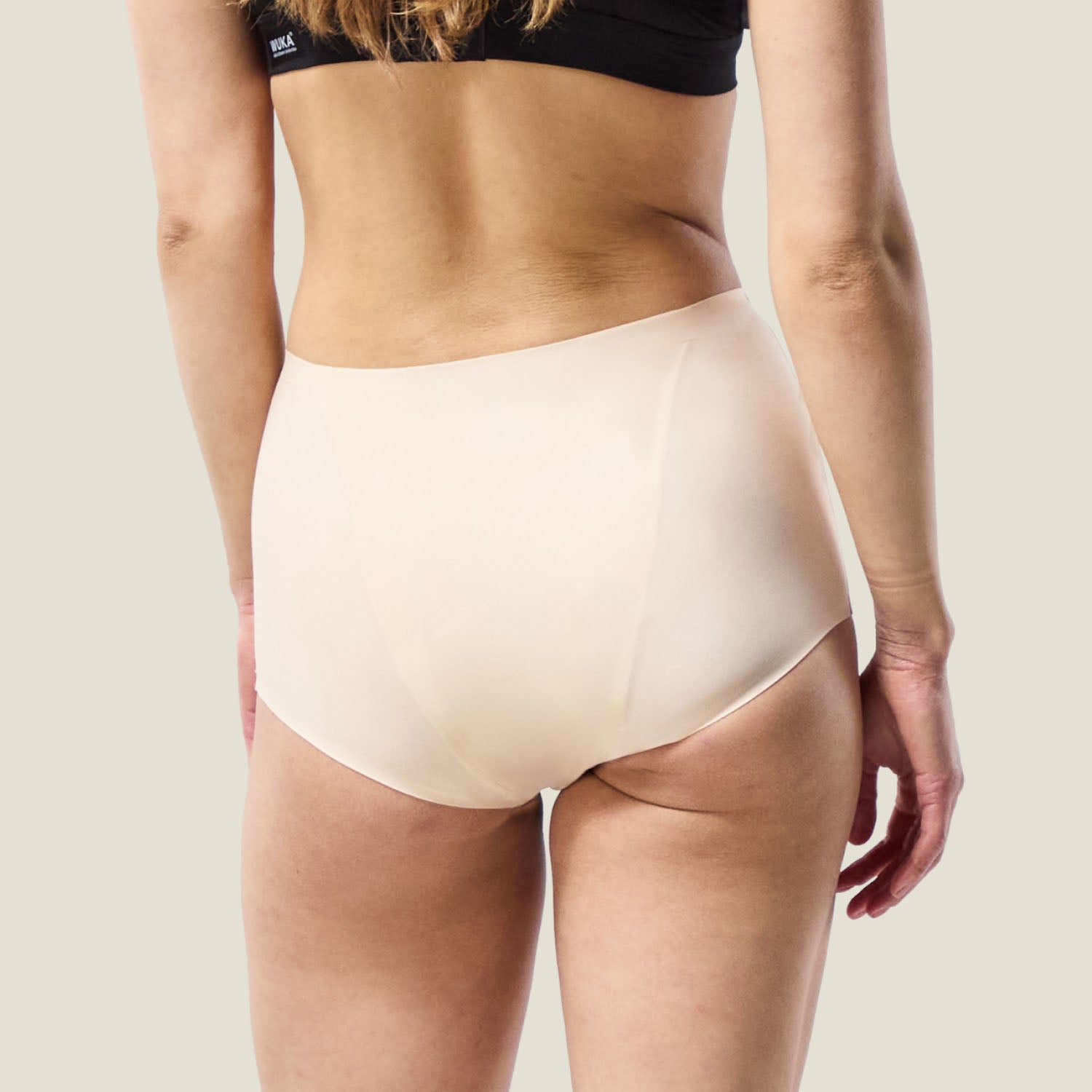 Back view of WUKA Stretch™ Boxer Short in Light Nude, designed for heavy flow with full coverage and a seamless finish.