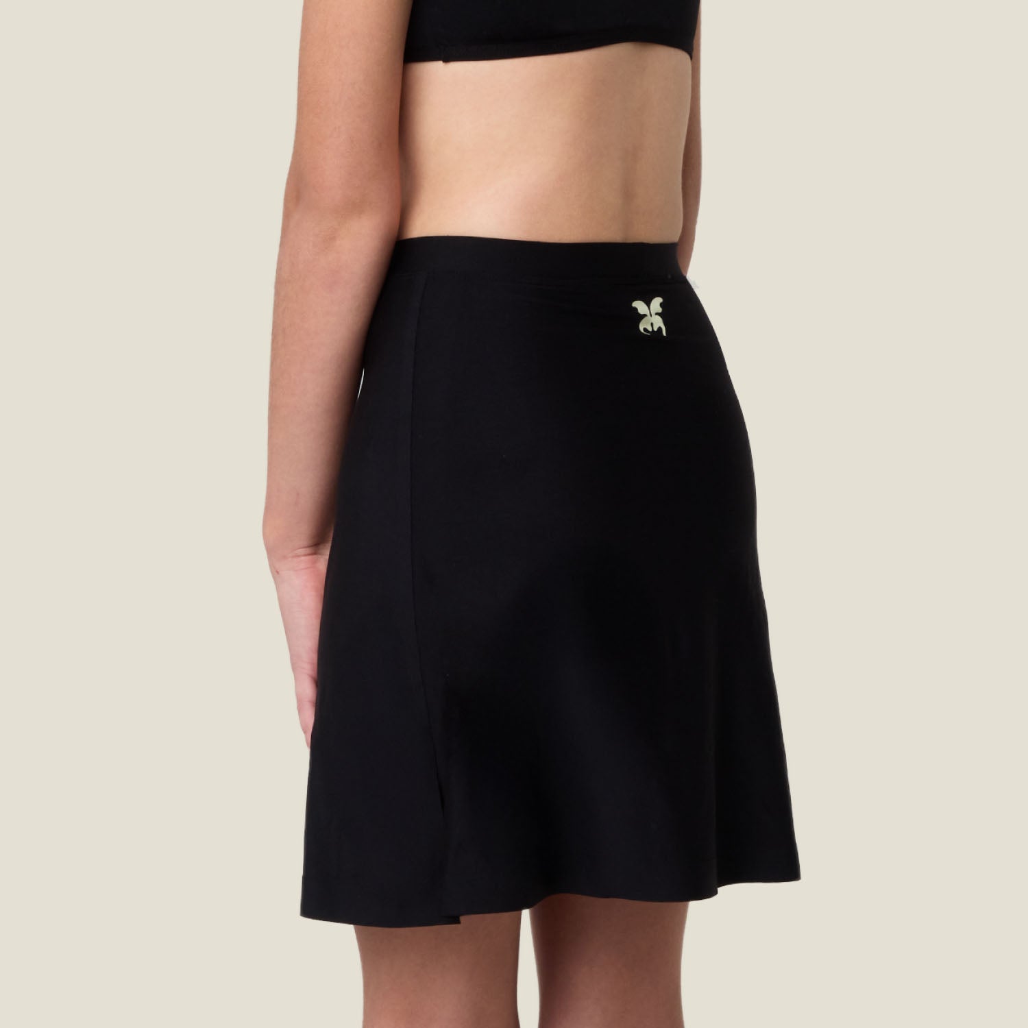 Back view of WUKA Teen Period Skort in black — high-stretch, leak-proof protection with discreet fit.