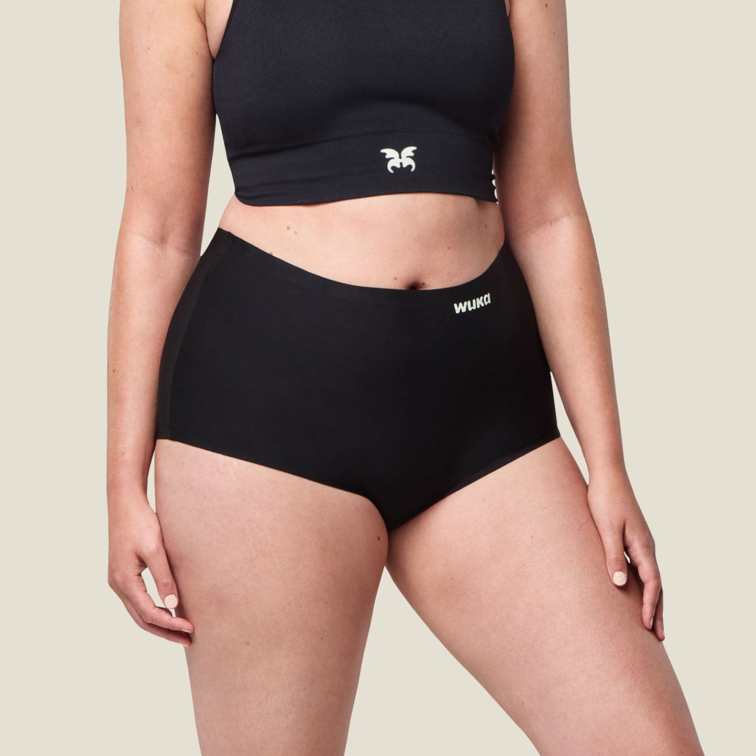 Detailed close-up of WUKA black boxer period pants fabric and stitching, emphasising quality, stretchability, and comfort.