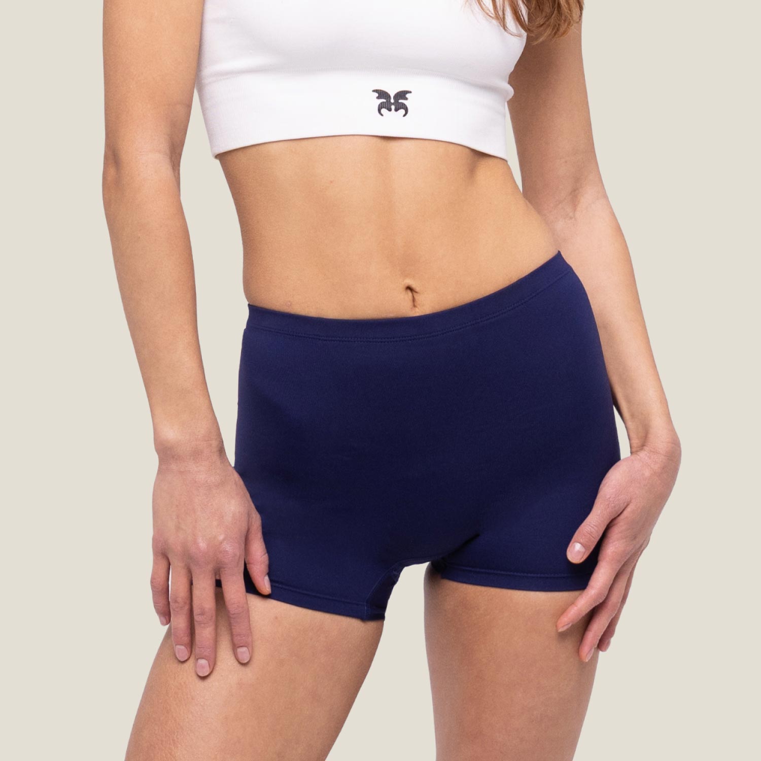 Adult female wearing navy blue swimming short by WUKA